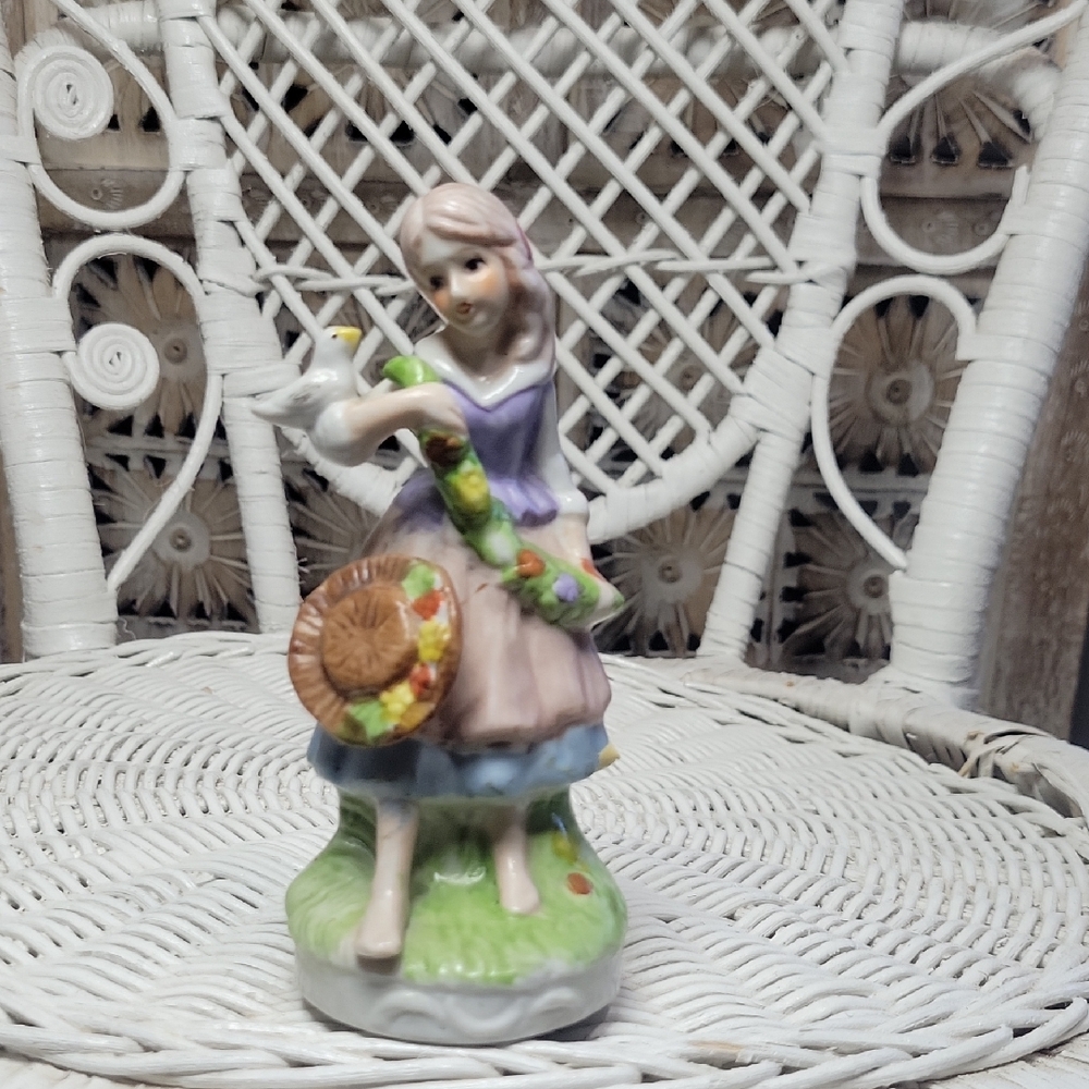 Charming Porcelain Figurine with Bird
